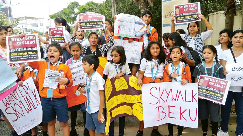 Bellandur residents hold a protest demanding a skywalk near Iblur Junction on Wednesday. (Photo: DC)
