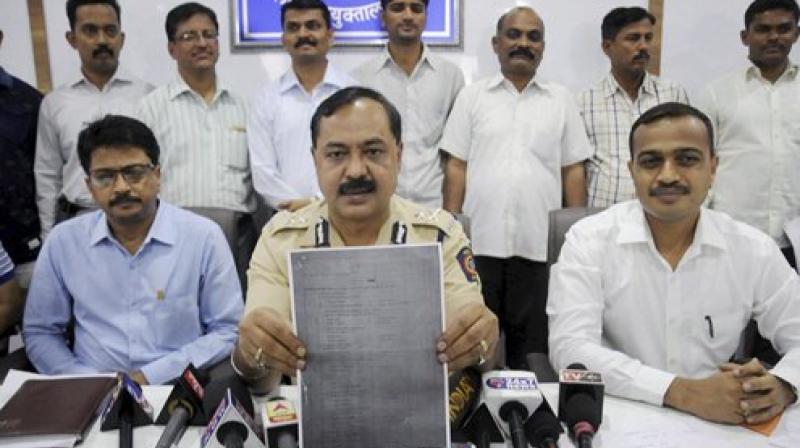 Thane Crime Branch officials show a examination paper of the Army Recruitment Board that was allegedly leaked. (Photo: PTI)