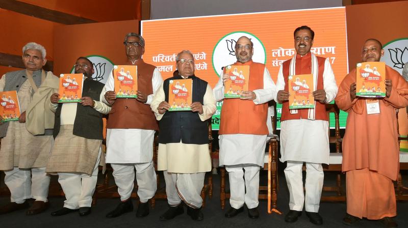 BJP President Amit Shah with UP BJP chief Keshav Prasad Maurya and others releasing party manifesto for the upcoming Uttar Pradesh assembly elections in Lucknow. (Photo: PTI)