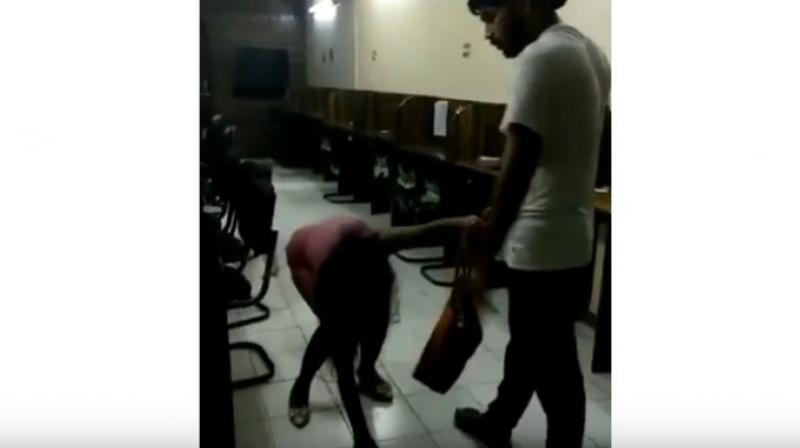 The man identified as Rohit Tomar, is seen brutally thrashing and kicking the woman with his knees and dragging her by her hair as she pleads for mercy.(Photo: YouTube | Screengrab)