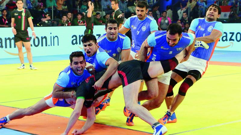 Indian players trap an Iranian raider during the kabaddi World Cup final in Ahmedabad on Saturday.