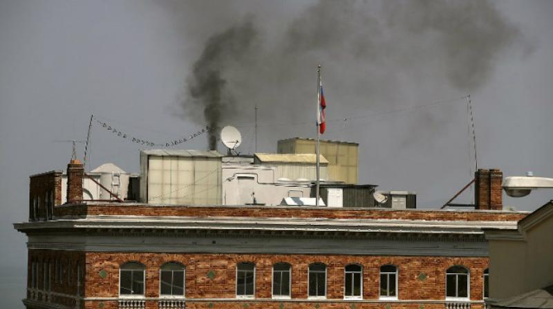 Black smoke billows from a chimney on top of the Russian consulate on eve of its closure. (Photo: AFP)