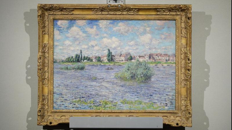Claude Monets \La Seine a Lavacourt\ hangs on display during an auction at Christies from the collection of Peggy and David Rockefeller, Tuesday, May 8, 2018, in New York. (Photo: AP)