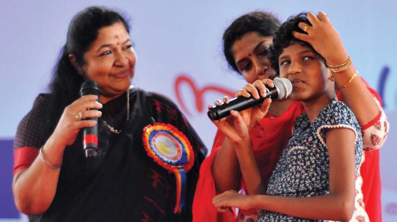 Singer Chithra is all ears when autistic kid Ananya rendered her well-known song Nanda Kishora Hare at the state level inaugural function of autism awareness programme organised by Centre for Autism in India in Thiruvananthapuram on Friday. (Photo: A.V. MUZAFAR)