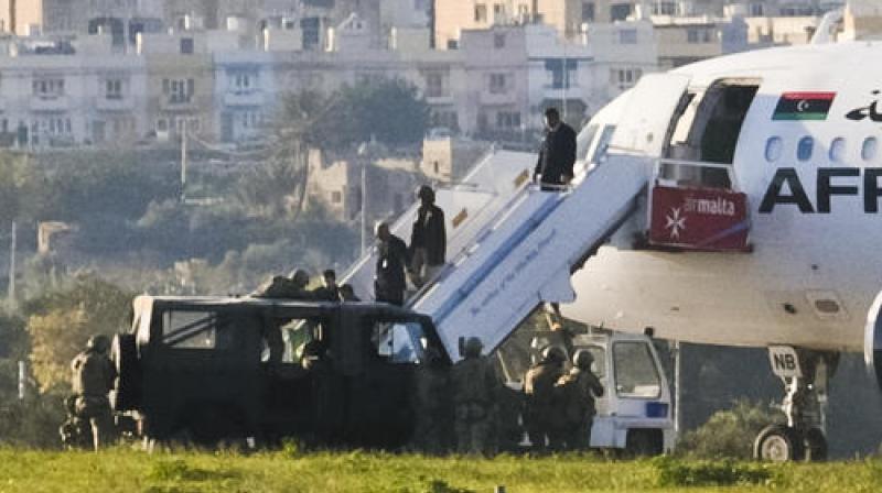 After hours of negotiations, the standoff ended peacefully with the hijackers freeing all 117 people on board and walking off the plane to surrender. (Photo: AP)