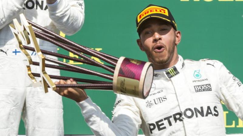 Mercedes driver Lewis Hamilton, of Britain, celebrates his victory at the Canadian Grand Prix auto race Sunday (Photo: AP)