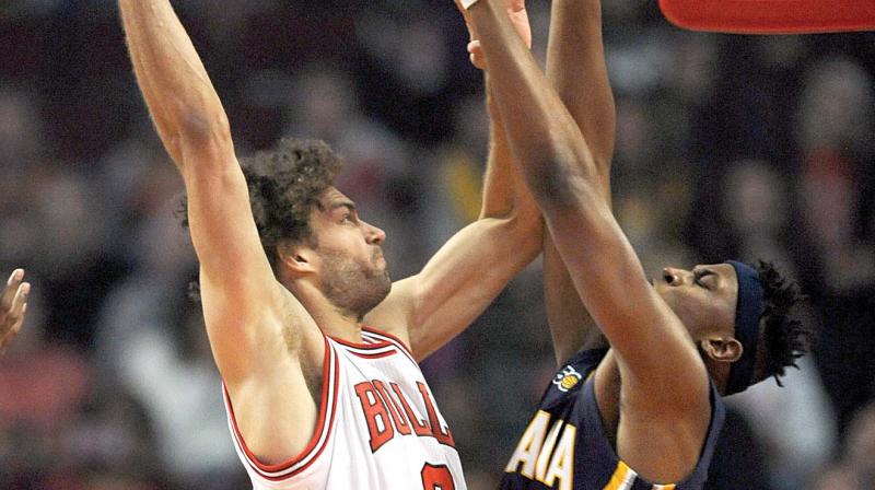 Chicago Bulls Robin Lopez (8) goes up to dunk against Indiana Pacers Myles Turner (33) in Chicago. (Photo: AP)