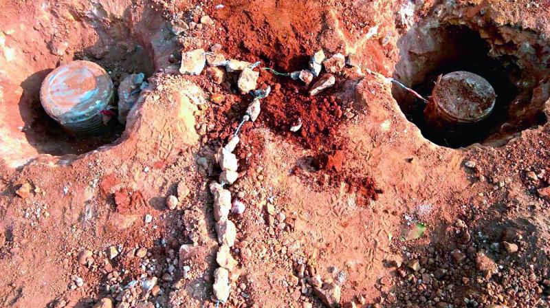 Special party police personnel unearth land mines which were planted by the Maoists near Munchungi-puttu in Visakhapatnam Agency on Friday. (Photo: DC)