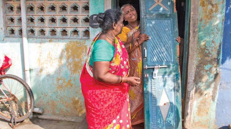 Women show door broken by police when they stormed into their  houses. (Photo: DC)