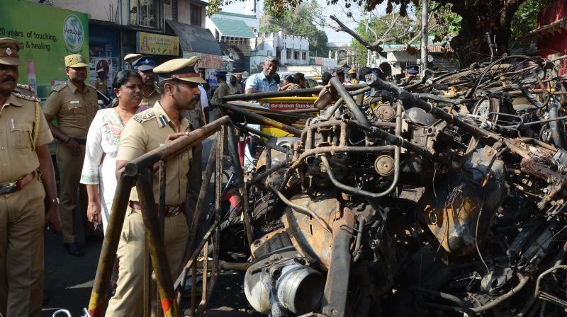 Deputy commissioners  R. Sudhakar and  S. Radhika having a look at the remains of burnt police  vehicles at Ice House police  station. (Photo: DC)