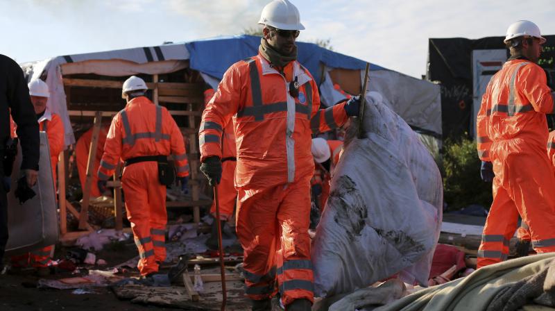 Crews start to demolish shelters in the makeshift migrant camp known as \the jungle\ near Calais, northern France, on Tuesday. (Photo: AP)