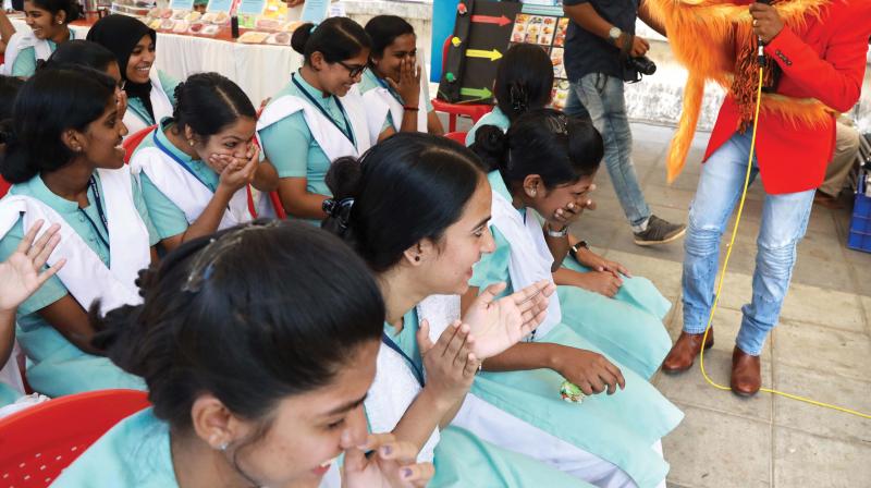 Nursing students in splits as ventriloquist Vinod Naranatt and his puppet Kitty interact during Healthy Food Plate Initiative in Kochi on Saturday. (Photo: ARUN CHANDRABOSE)