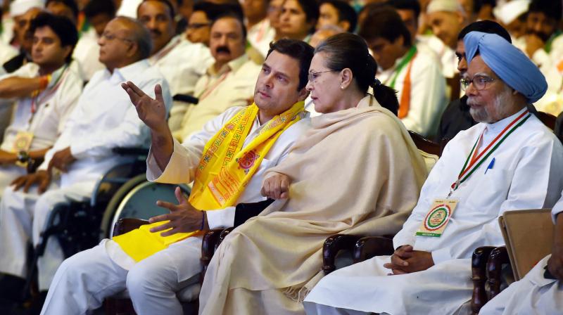 Chairperson CPP Sonia Gandhi and President Rahul Gandhi talk as former Prime Minister Manmohan Singh looks on, during the 84th Plenary Session of Indian National Congress (INC) at the Indira Gandhi Stadium in New Delhi on Saturday. (Photo: PTI)