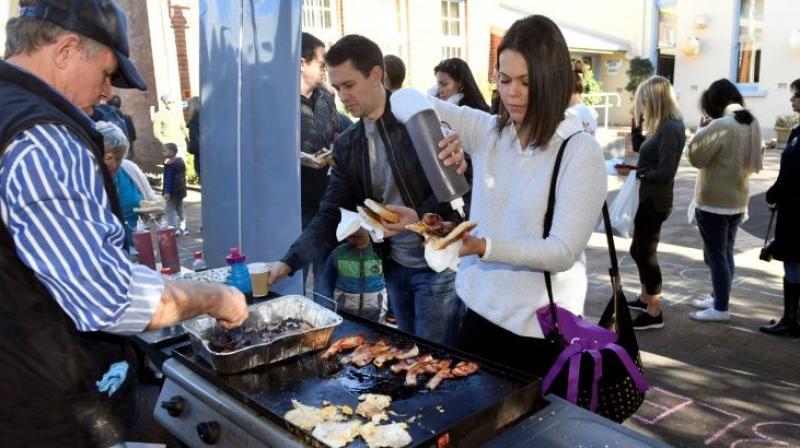 The Australian word of the year 2016 is democracy sausage, a barbecued sausage bought at a polling station on election day. (Photo: AFP)