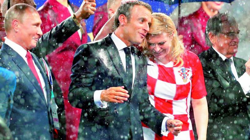 Russian president Vladimir Putin, French president Emmanuel Macron and Croatian president Kolinda Grabar-Kitarovic share a light moment after France won the World Cup.