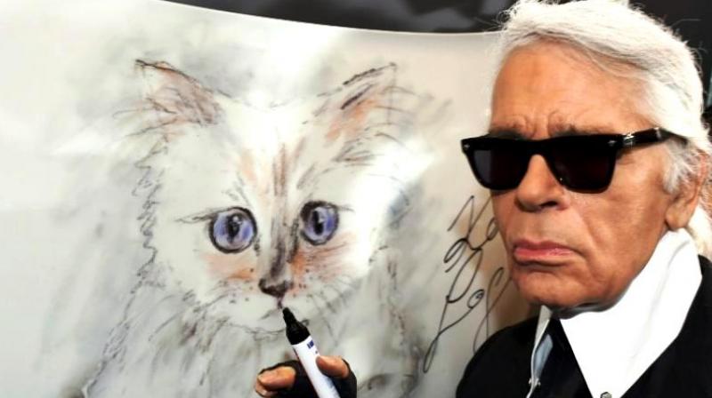 There is much speculation about whether his beloved fluffy white Birman cat, Choupette, will be present. (Photo: AFP)