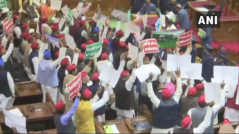 The opposition members also had posters in their hands in which the CBI was shown as a cadged parrot. One of these posters had a picture of a dog with a strap attached to its neck and CBI was written on it. (Photo: ANI)
