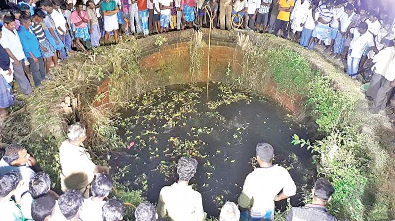 Crowd gathers around the farmwell near Arakonam from where the bodies of the girls were fished out. (Photo: DC)