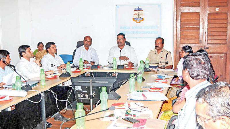 Chennai district electoral officer and corporation commissioner D. Karthikeyan addresses a meeting convened to expedite preparedness for RK Nager bypoll, on Friday. District collector V. Anbuselvan and others attended the meeting. (Photo: DC)