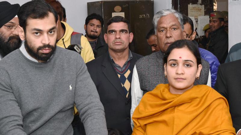 Aparna Yadav (SP), daughter-in-law of Mulayam Singh Yadav, filling her nomination papers for UP Assembly Election in Lucknow as her husband (L) Prateek Yadav looks on. (Photo: PTI)