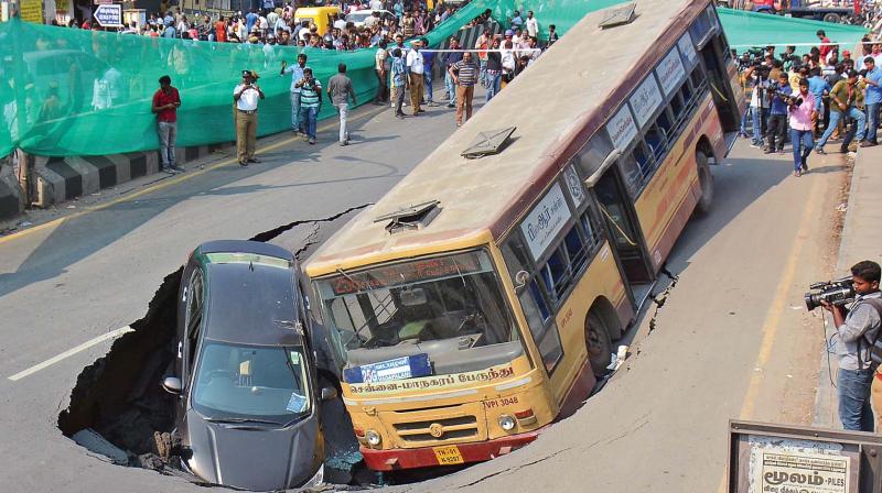 An MTC bus and a car were trapped in a crater which developed on Anna Salai on Sunday afternoon. (Photo: EK Sanjay)