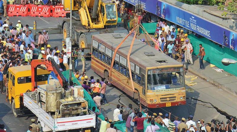 Fire and Rescue department personnel pull out the bus from the crater using cranes on Anna Salai on Sunday. (Photo: DC)