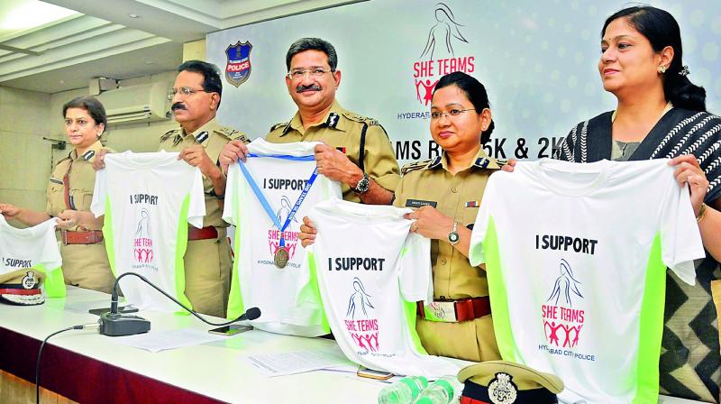 DGP Anurag Sharma unveils the â€œI Support SHE Teamsâ€ T-shirts as part of the build-up to the SHE Run on March 5, at Peoples Plaza, at the DGPs office in Hyderabad on Monday. Hyderabad police commissioner M. Mahendar Reddy, SHE teams head Swathi Lakra and other senior police officers are also seen. (Photo: DC)