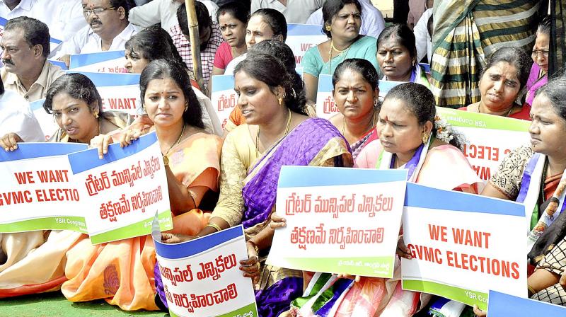 YSR Congress activists stage a sit-in protest against the government near GVMC Gandhi Statue junction in Visakhapatnam on Monday, demanding GVMC elections. (Photo: DC)