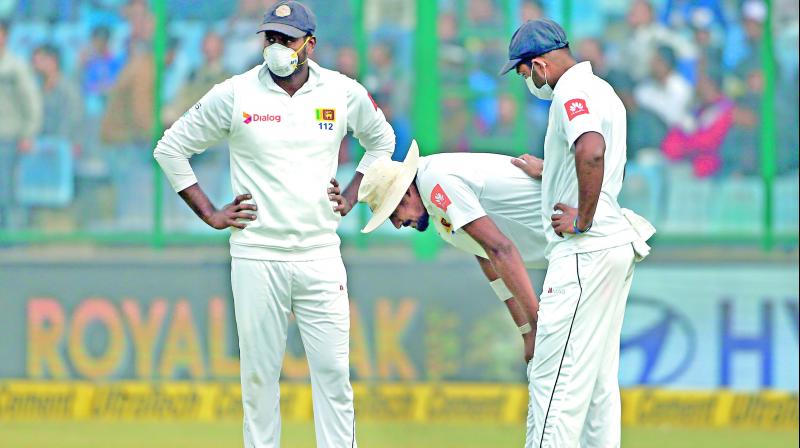 Sri Lanka quick Suranga Lakmal (centre) vomited twice between overs on Tuesday. 	PTI