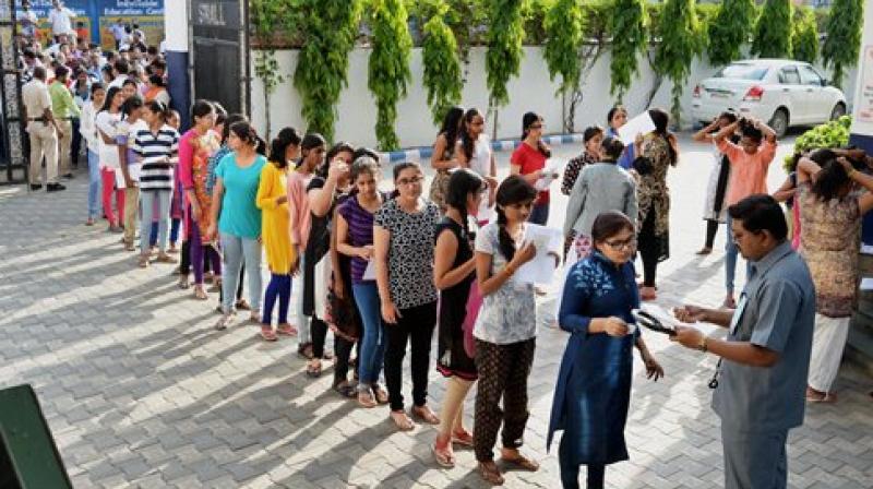 Candidates being checked before appearing for the NEET exam in Jabalpur on Sunday. (Photo: PTI)