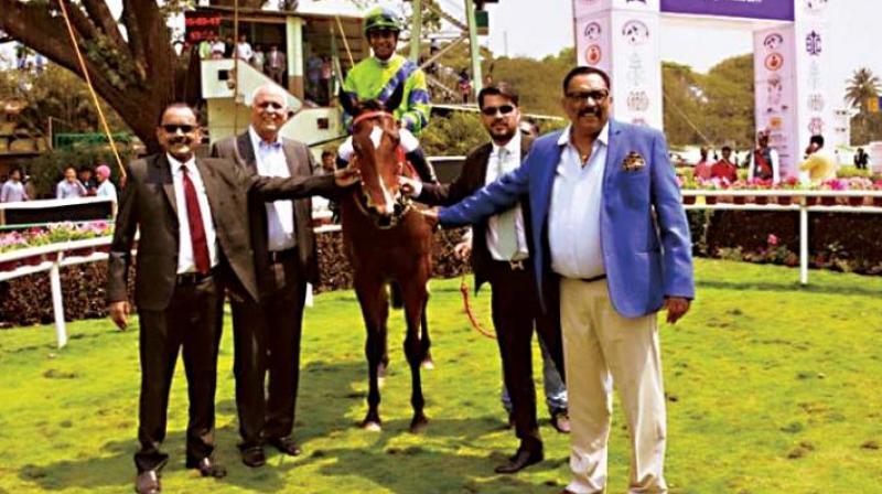 Queen Latifa with her owners and trainer in March.