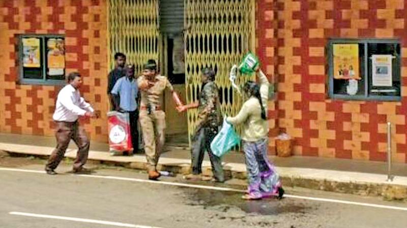 Parents of a college girl attempted self-immolation in front of a bank in Wellington cantonment in Nilgiris on Friday. (Photo: DC)