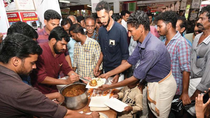 SFI activists serve beef as part of the beef festival organised in protest against Centres notification banning cattle sale for slaughter at Moffusil Bus stand in Kozhikode on Saturday. (Photo: DC)