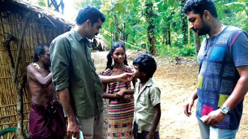District Child Protection officer Subair and other NGO volunteers interact with children during a visit to tribal huts in the Anakaal hamlet of Kottoor. (File pic)