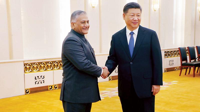 Minister of State for External Affairs General V K Singh shake hands with Chinese President Xi Jinping at Beijing on Monday. (Phtoo: PTI)