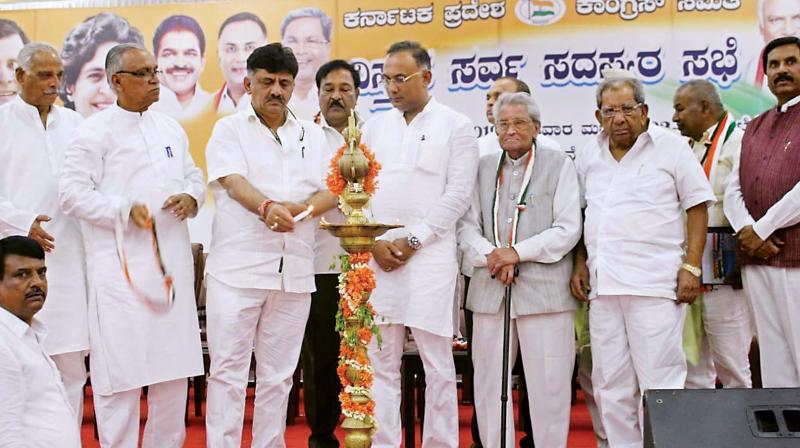 KPCC president Dinesh Gundurao and Water Resources Minister D.K. Shivakumar at a party meeting in Bengaluru on Wednesday