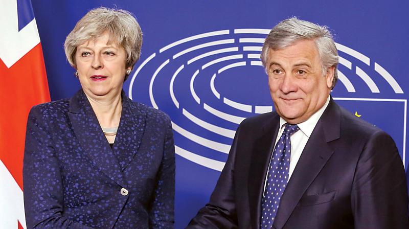 European Parliament President Antonio Tajani shakes hand with British Prime Minister Theresa May before a meeting at the European Parliament in Brussels on Thursday, after she agreed earlier with European Union president Jean-Claude Juncker to hold further talks on Britains withdrawal from the bloc, after what they described as a robust meeting  AFP