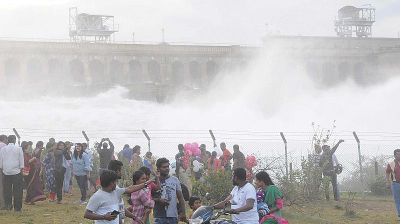 The release of water from KRS dam in Mandya attracts people on Sunday. Water was released from the dam after the level reached the maximum.