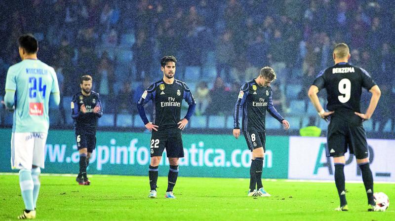 Real Madrid players react after a goal scored by Celta Vigo during their Copa del Rey quarterfinal second leg football match at the Balaidos stadium in Vigo, Spain, on Wednesday. Madrid drew the game 2-2 but lost the tie 3-4 on aggregate. (Photo: AP)