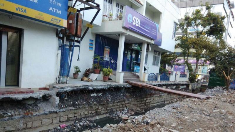 The dug up drains in HSR Layout Sector 6 and 7 have become an accident prone area as the pedestrians are compelled to walk on the road. (Photo: DC)