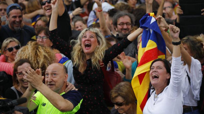 Protesters reacts as they watch the parliament session on a huge screen during a rally outside the Catalan Parliament, in Barcelona, Spain. Catalonias regional Parliament passed a motion Friday to establish an independent Catalan Republic. (Photo: AP)