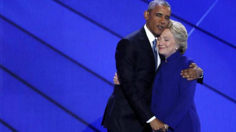 President Barack Obama and Democratic Presidential candidate Hillary Clinton wave together during the third day of the Democratic National Convention in Philadelphia. (Photo: AP)