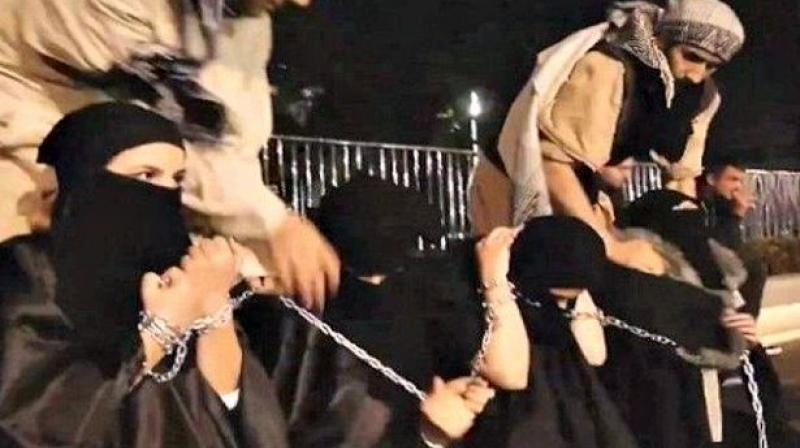 ISIS fighters with captured sex slaves (Photo: YouTube screen grab)