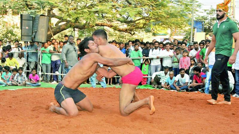 Wrestlers grapple with each other at a recent wrestling competition that was held in the city.  (Photo: DC)