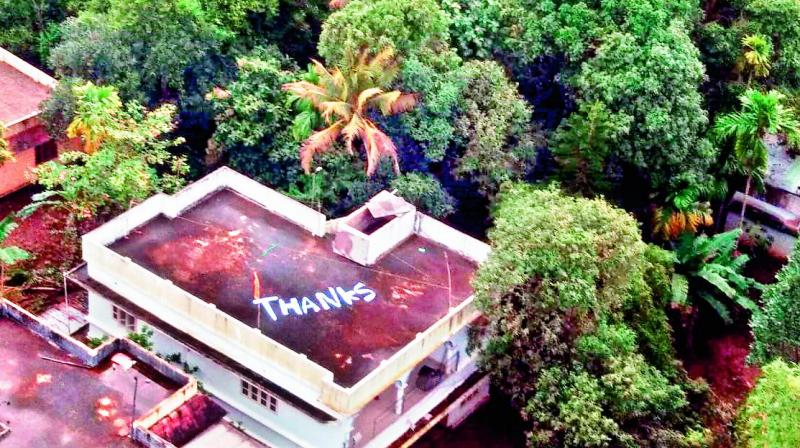 Thanks written on the roof of a building to convey Kerala peoples gratitude to Indian Navy and Air Force for their rescue and relief operations towards the flood-affected people, at Chengamanad near Aluva, on Monday. The Indian Navy squadron 321 is known as the Angels and incidentally those serving at the southern naval command in Kochi refer to themselves as Gods Own Angels after the famous moniker coined in by the states tourism  department.