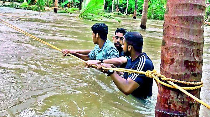 Navy volunteers helping with rescue operation in Ernakulam district on Monday.