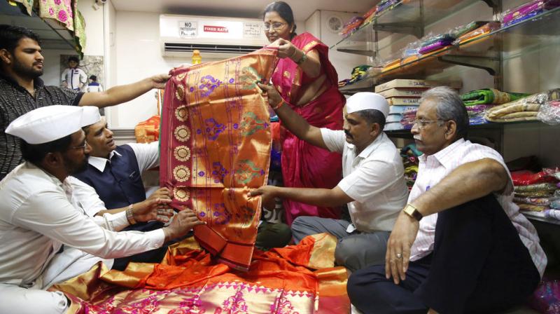 Mumbai dabbawalla look at traditional attire to send as gifts for the wedding of Britains Prince Harry and Meghan Markle on Thursda. (Photo: AP)