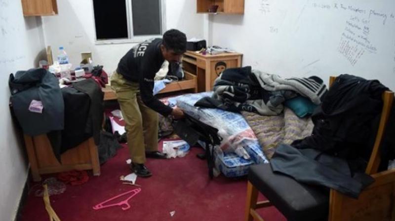Policeman inspect Mashal Khans hostel room. (Photo: AFP)