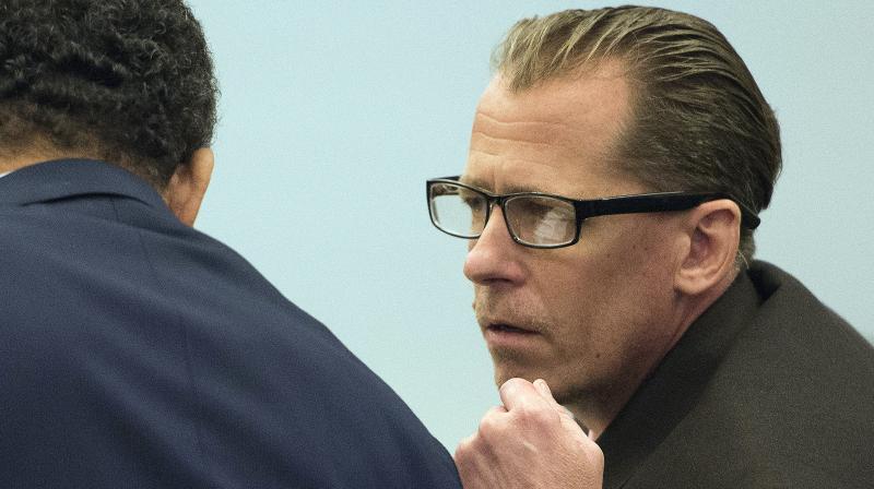 Steven Dean Gordon, right, leans over to talk to his court-appointed investigator during opening statements in his trial on Wednesday. (Photo: AP)