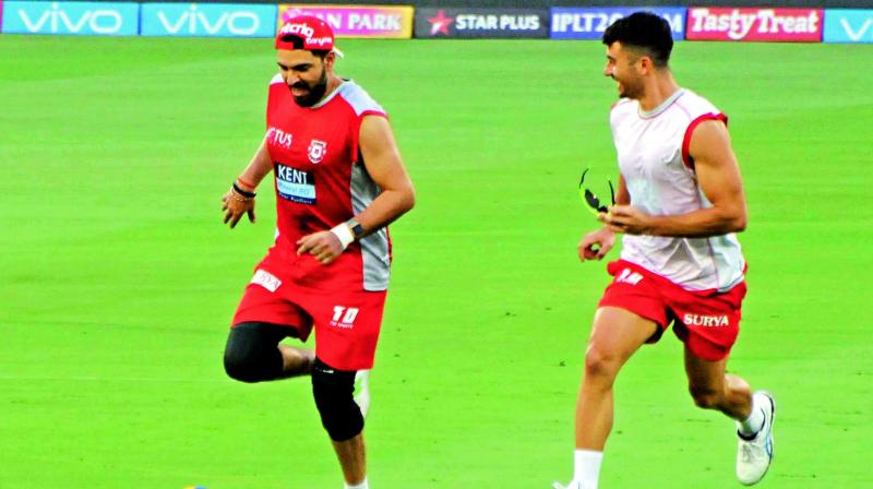 Kings XI Punjabs Yuvraj Singh (left) and Marcus Stoinis play football during their training session. (Photo: Deepak Deshpande)